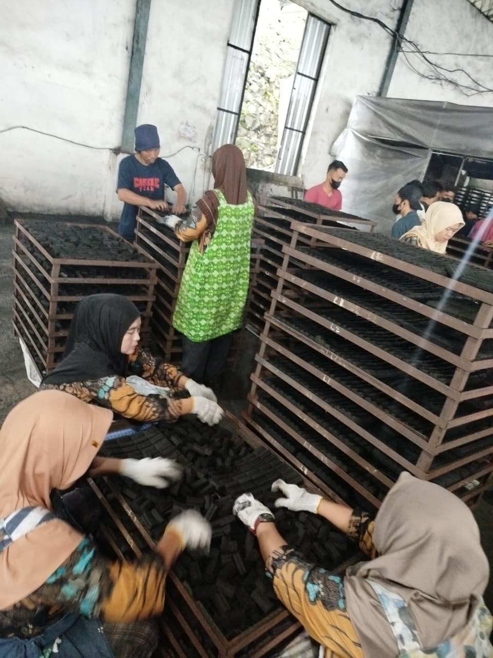 Massive warehouse filled with stacked bags of raw charcoal